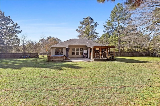 rear view of house with a lawn and a patio