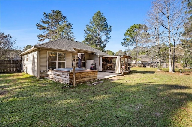 rear view of house with a patio area and a lawn