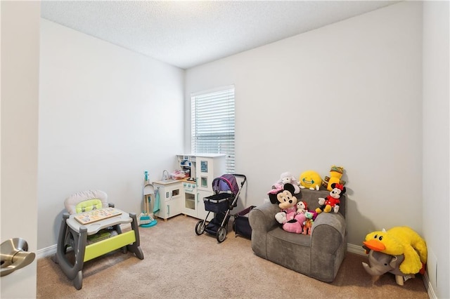 game room featuring light colored carpet and a textured ceiling