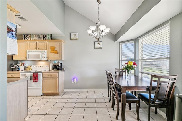 kitchen featuring light brown cabinets, lofted ceiling, white appliances, light tile patterned floors, and decorative light fixtures