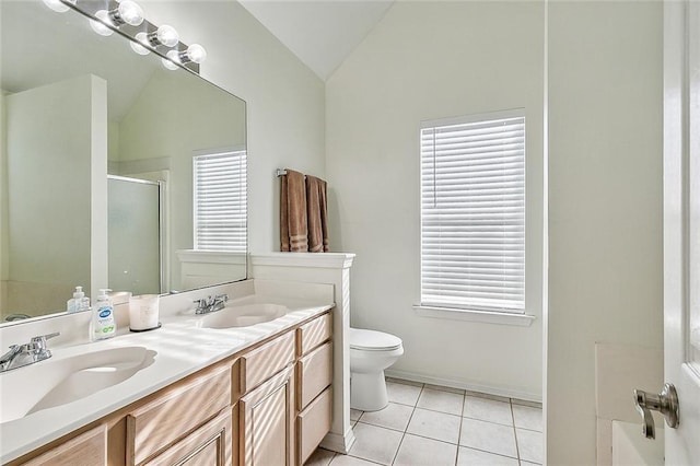 bathroom with tile patterned flooring, vanity, walk in shower, and vaulted ceiling