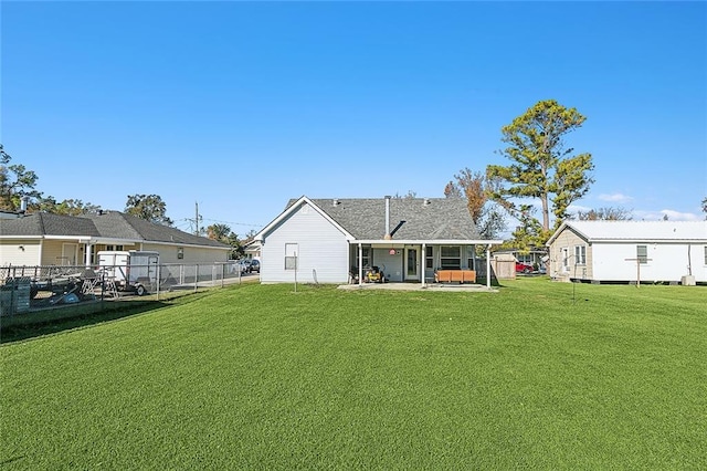 back of property with a patio and a lawn