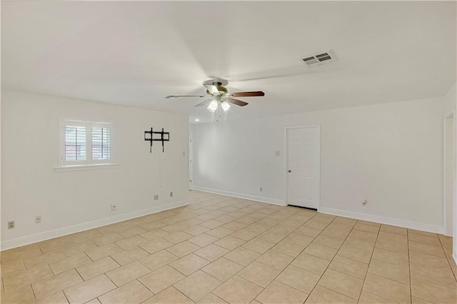 spare room featuring ceiling fan and light tile patterned flooring