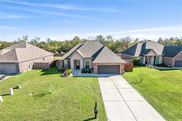 ranch-style house with a garage and a front yard