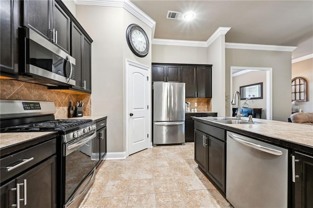 kitchen with tasteful backsplash, sink, ornamental molding, dark brown cabinetry, and stainless steel appliances