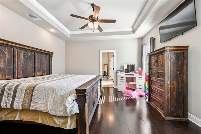 bedroom with ceiling fan, ornamental molding, dark hardwood / wood-style floors, and a raised ceiling