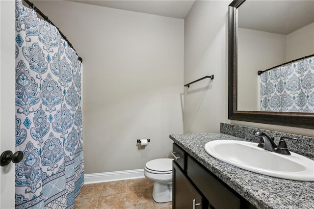 bathroom featuring tile patterned flooring, vanity, and toilet