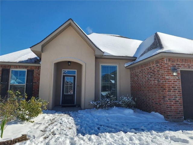 view of snow covered property entrance