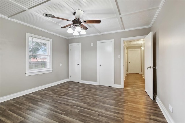 unfurnished bedroom featuring ornamental molding, ceiling fan, and dark wood-type flooring