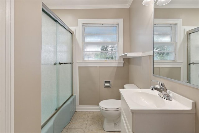 full bathroom featuring vanity, crown molding, enclosed tub / shower combo, tile patterned flooring, and toilet