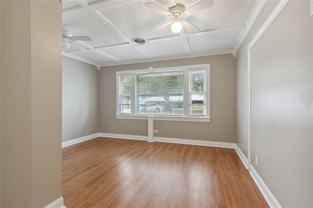 empty room featuring wood-type flooring, ceiling fan, ornamental molding, and coffered ceiling