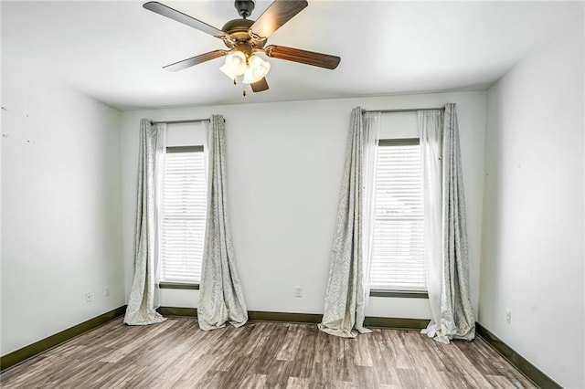 empty room with hardwood / wood-style flooring and ceiling fan