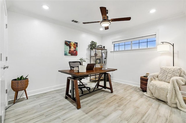 office space featuring ceiling fan, light wood-type flooring, and ornamental molding