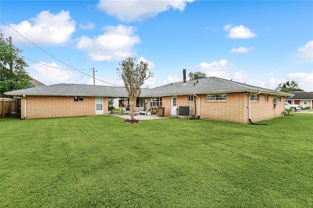 back of property with an outdoor hangout area, a patio, cooling unit, and a lawn