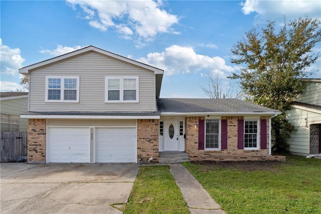 tri-level home featuring a front yard and a garage