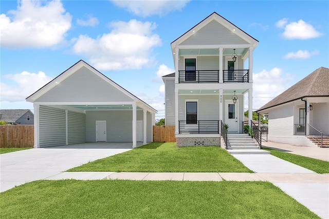 view of front of house featuring a balcony, covered porch, a front yard, and a carport