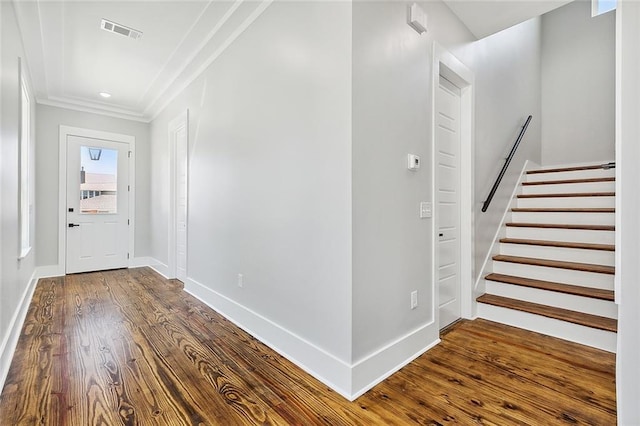 entrance foyer featuring wood-type flooring and crown molding