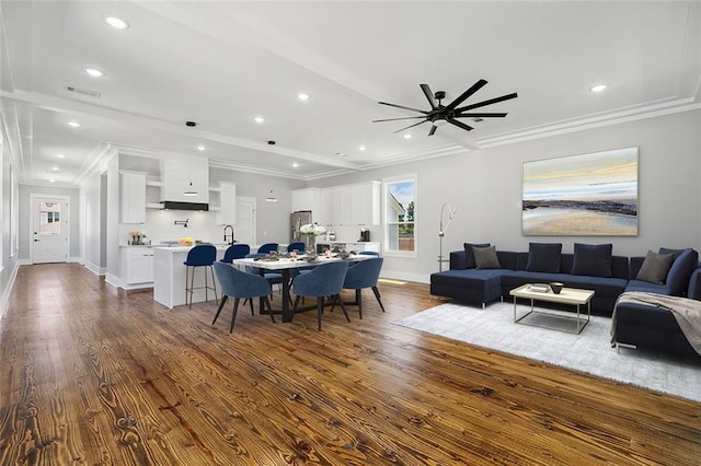 living room with ceiling fan, dark hardwood / wood-style flooring, and ornamental molding