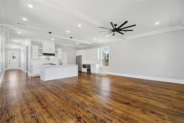 unfurnished living room with sink, ceiling fan, dark hardwood / wood-style flooring, and crown molding