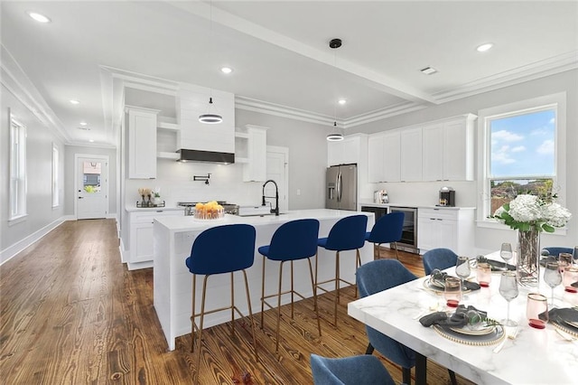 kitchen featuring white cabinets, dark wood-type flooring, stainless steel refrigerator with ice dispenser, and beverage cooler