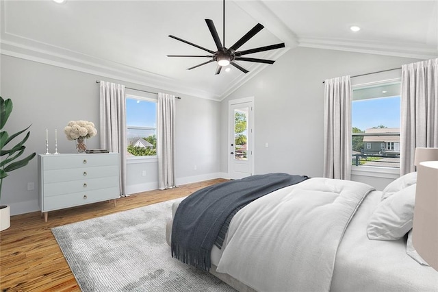 bedroom featuring ceiling fan, light hardwood / wood-style floors, and lofted ceiling with beams