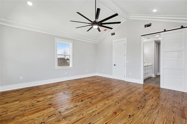 unfurnished room with hardwood / wood-style flooring, vaulted ceiling with beams, a barn door, and ceiling fan