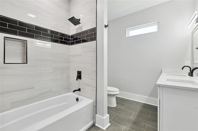 full bathroom featuring vanity, tile patterned floors, tiled shower / bath combo, and toilet