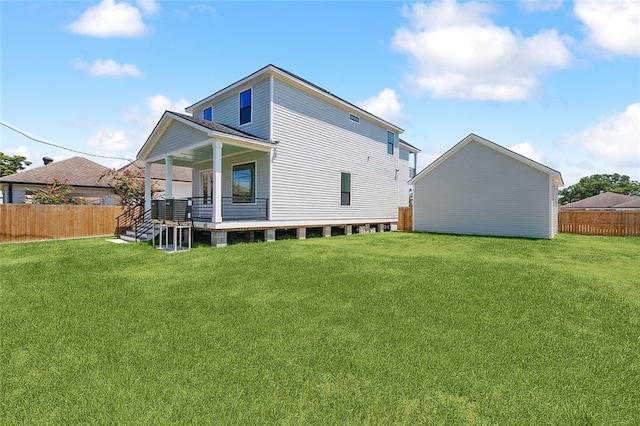 back of property with a lawn and a porch