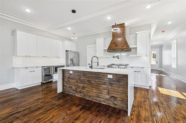 kitchen featuring sink, appliances with stainless steel finishes, decorative light fixtures, dark hardwood / wood-style flooring, and white cabinetry