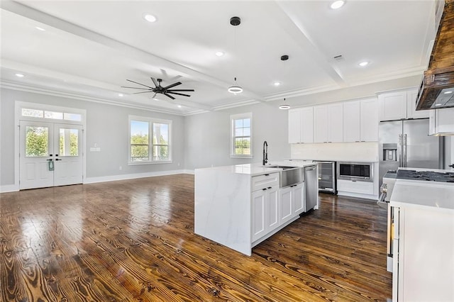 kitchen with white cabinets, dark hardwood / wood-style floors, ceiling fan, and sink