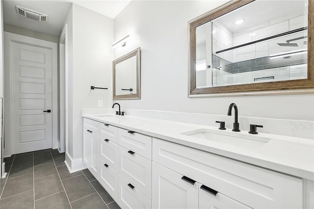 bathroom with tile patterned flooring, vanity, and a shower with shower door