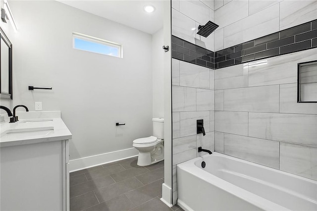 full bathroom with vanity, tile patterned floors, tiled shower / bath combo, and toilet