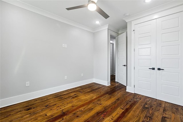 unfurnished bedroom featuring a closet, ceiling fan, crown molding, and dark wood-type flooring