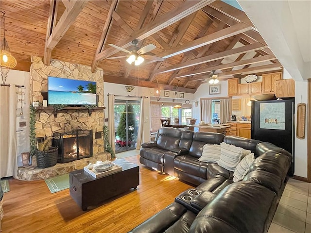 living room with lofted ceiling with beams, wooden ceiling, a fireplace, and light hardwood / wood-style floors