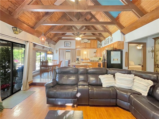 living room with ceiling fan, wood ceiling, beam ceiling, and light hardwood / wood-style flooring