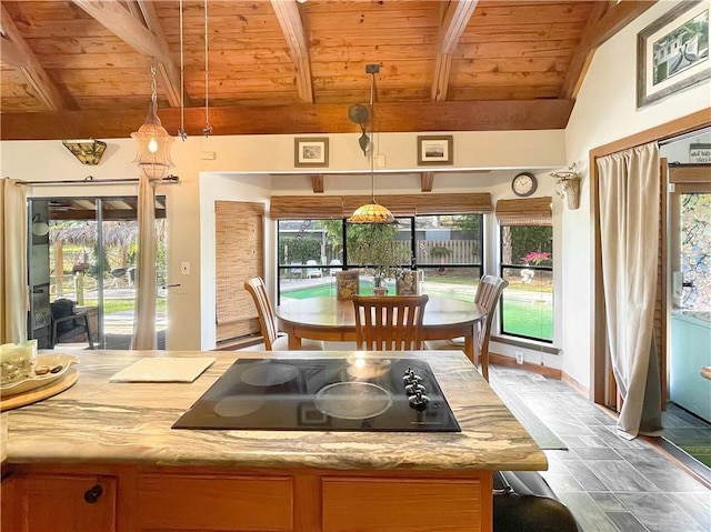 kitchen featuring pendant lighting, black electric cooktop, lofted ceiling with beams, and wooden ceiling