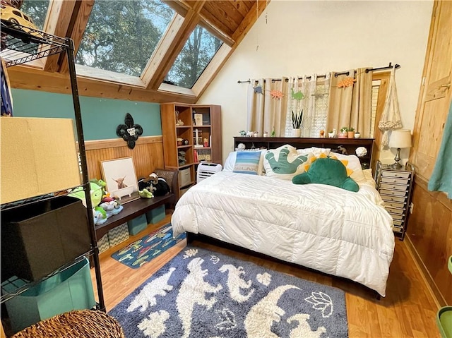 bedroom with wood-type flooring and vaulted ceiling with skylight