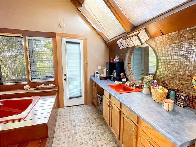 bathroom featuring lofted ceiling with beams and vanity