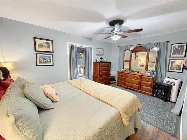 bedroom featuring wood-type flooring and ceiling fan