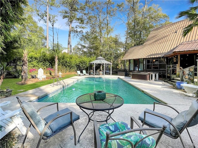 view of swimming pool with a hot tub, a gazebo, and a patio area