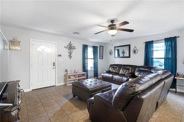 tiled living room featuring ceiling fan