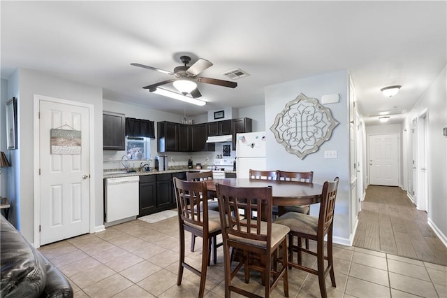 dining area with ceiling fan, sink, and light tile patterned floors