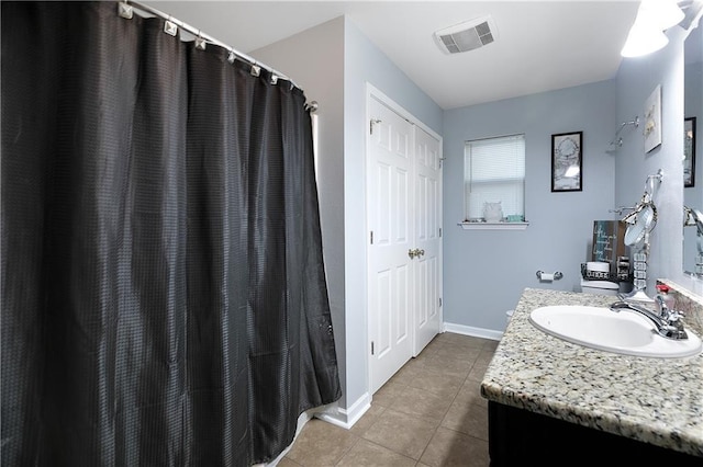 bathroom with tile patterned flooring and vanity