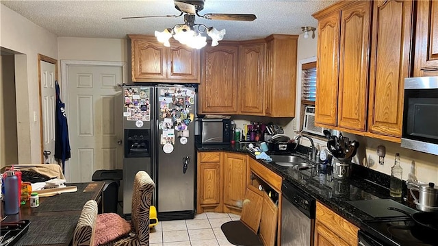 kitchen featuring ceiling fan, sink, stainless steel appliances, a textured ceiling, and light tile patterned floors