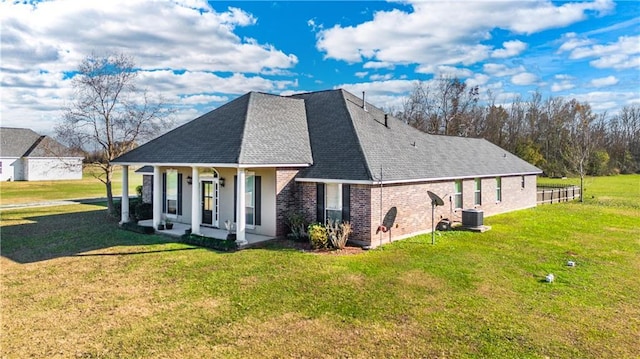 view of home's exterior with a lawn and covered porch