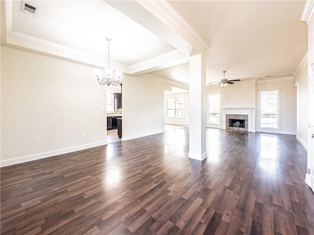 unfurnished living room featuring a tiled fireplace, crown molding, ceiling fan with notable chandelier, and dark hardwood / wood-style floors