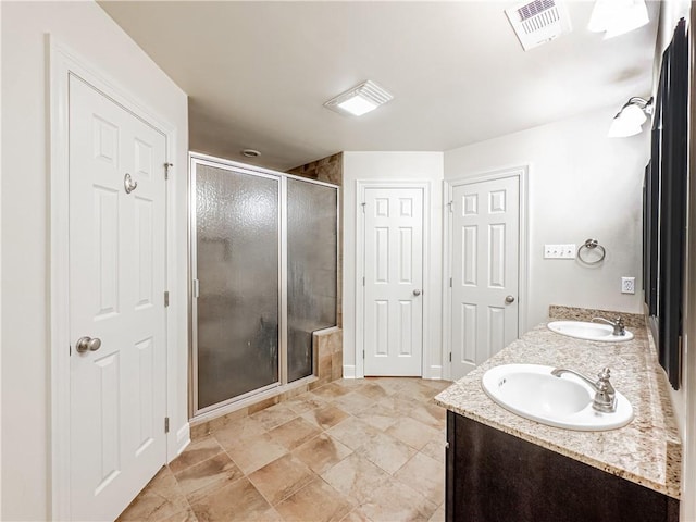 bathroom with vanity and an enclosed shower