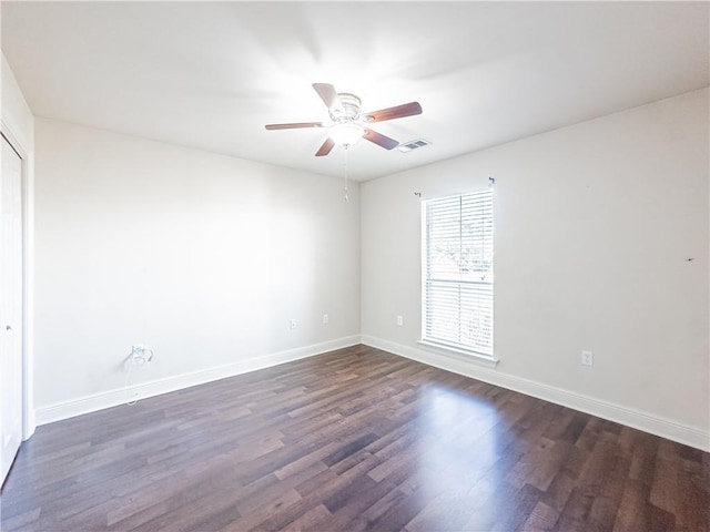 spare room with ceiling fan and dark hardwood / wood-style flooring