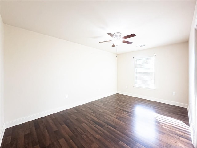 unfurnished room featuring ceiling fan and dark hardwood / wood-style floors