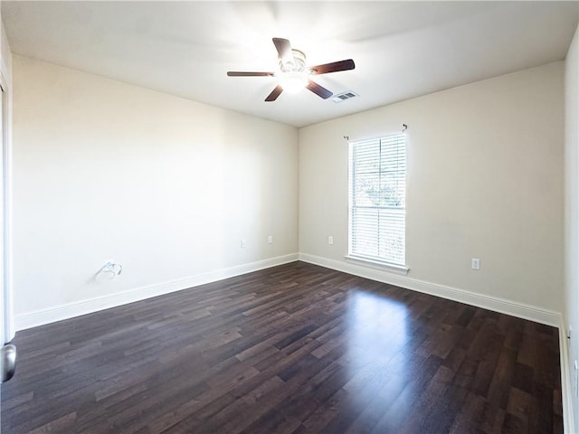 spare room featuring dark hardwood / wood-style flooring and ceiling fan